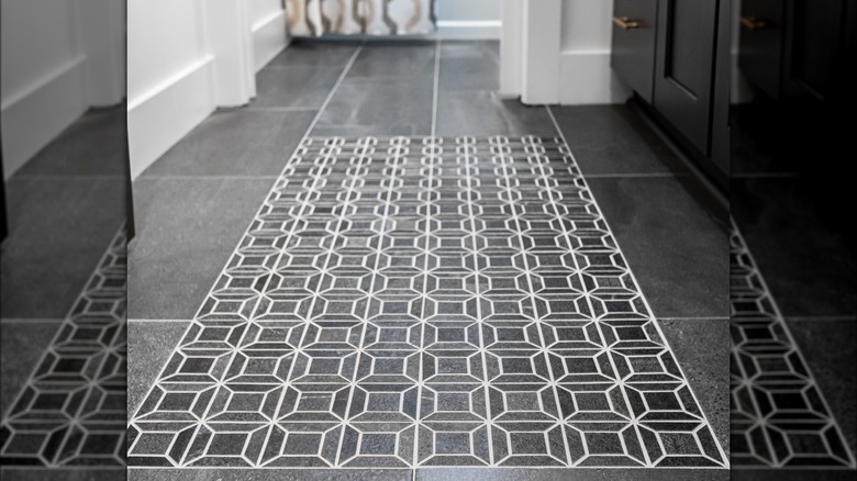 Section of geometric tile flooring in bathroom