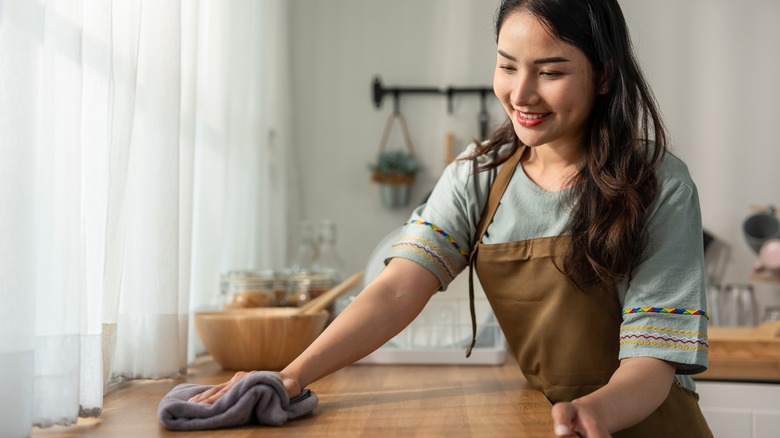 woman wiping counter