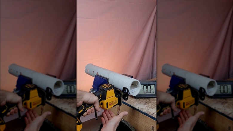 person cutting PVC pipe with DeWalt saw