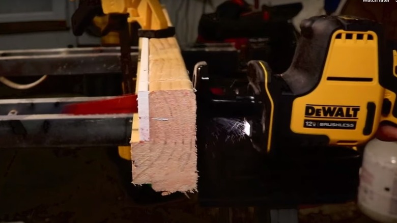 person cutting with DeWalt saw