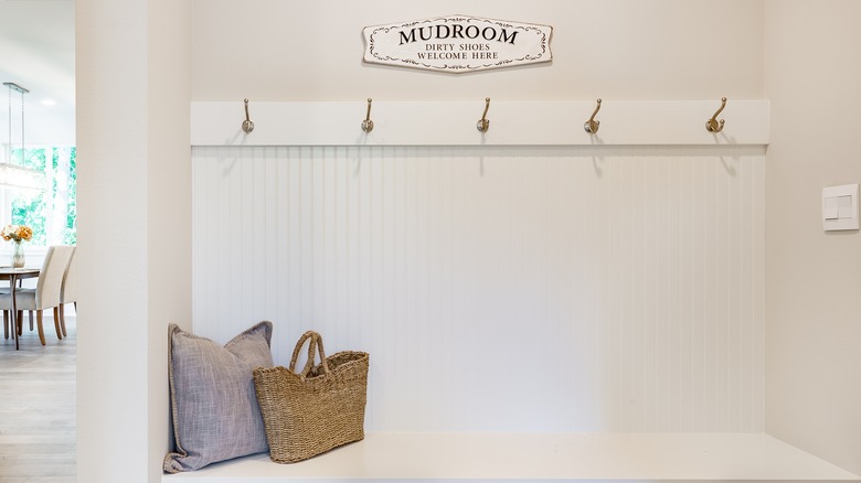 white coat rack in mudroom 