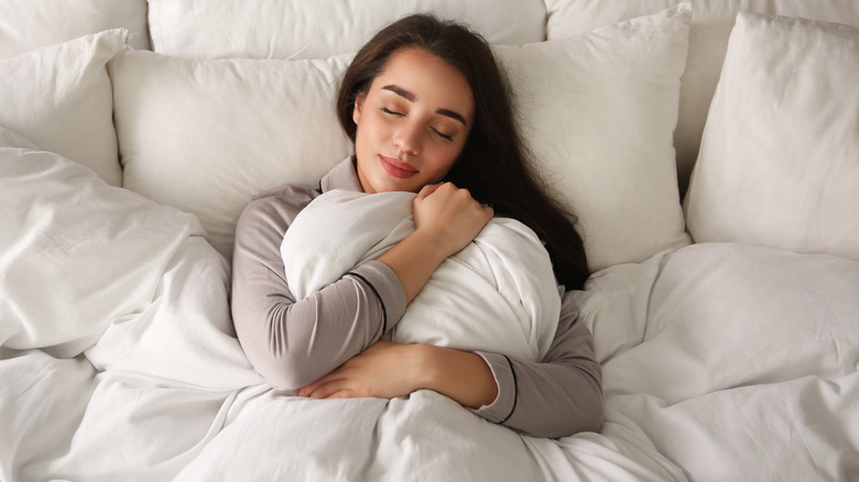 person sleeping under blanket