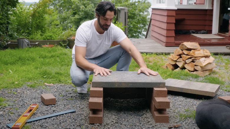 Man building brick oven 