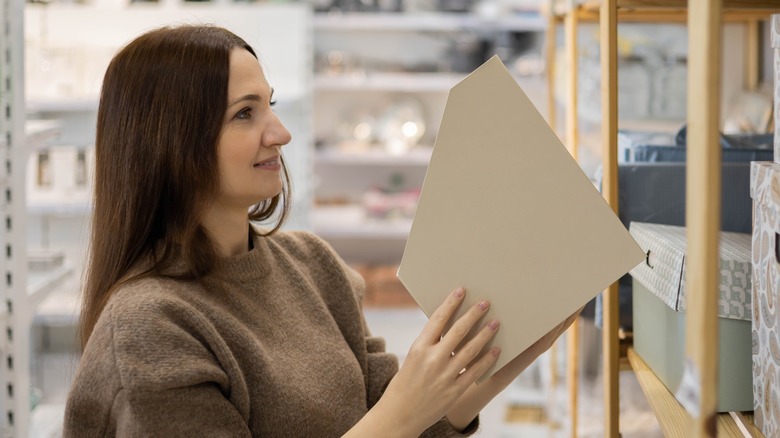 woman holding cardboard file organizer 