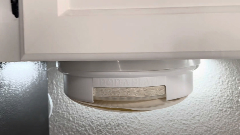 paper plate dispenser under kitchen cabinet