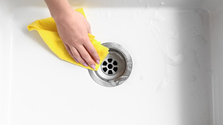 Woman cleaning sink