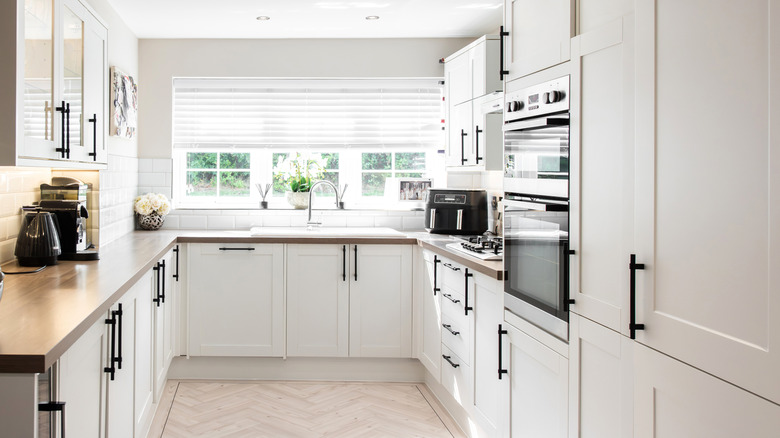 A modern kitchen with white cabinets