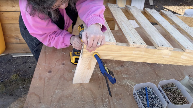 person making pallet chair legs