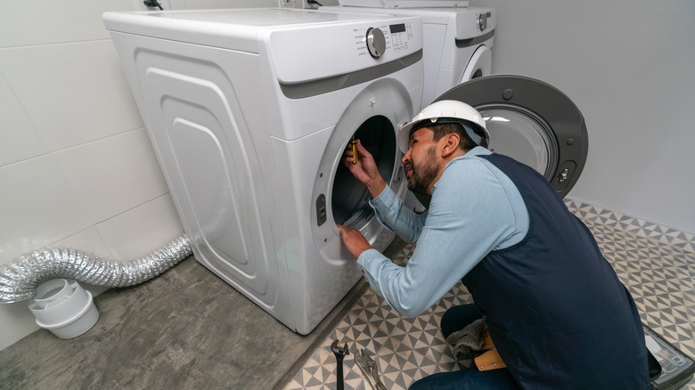 man fixing dryer