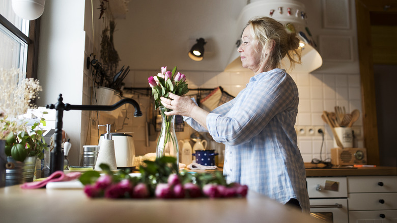 woman arranging flowers