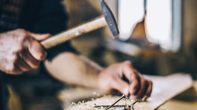 Person hammering nails