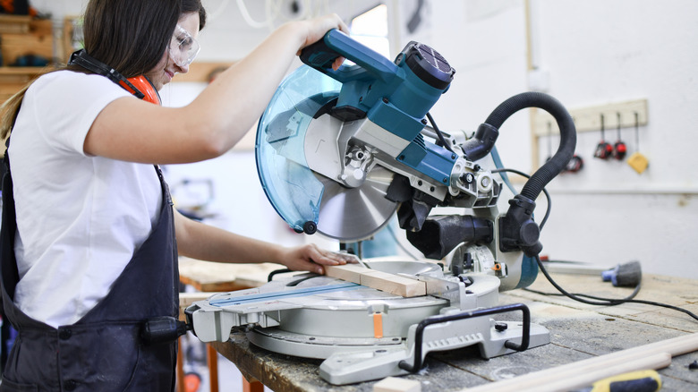 woman using miter saw