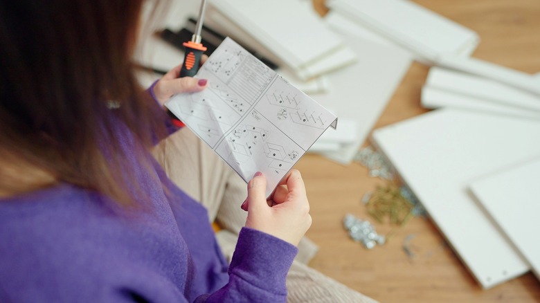 Woman checking furniture instructions