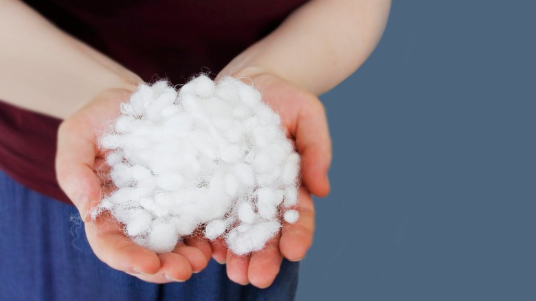 woman holding polyester filling