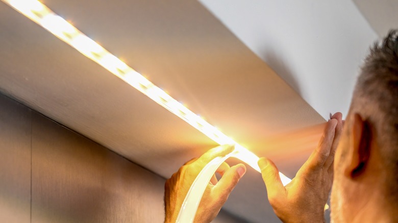 Man installing LED strip lights