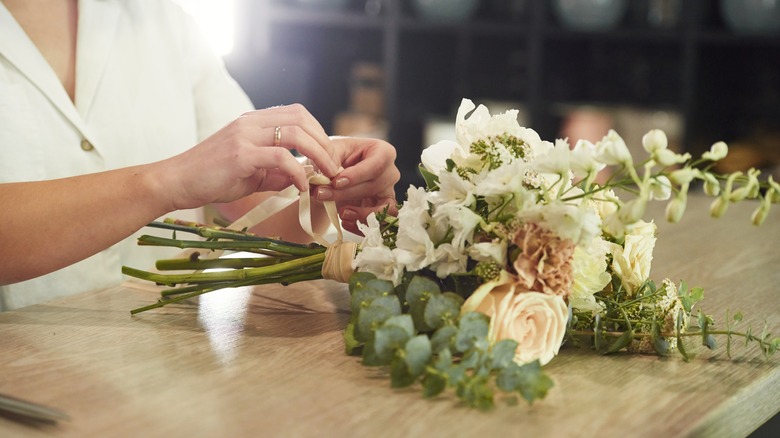 woman handling faux flowers