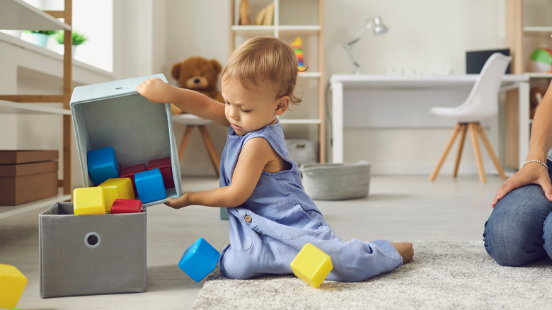 Child putting away toys