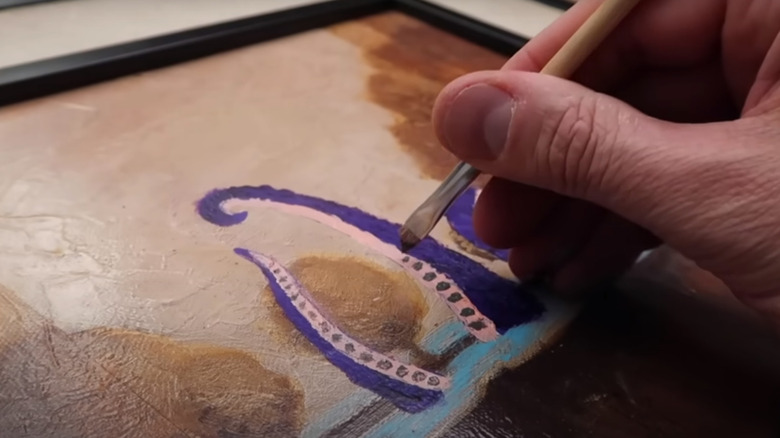 person painting sea monster