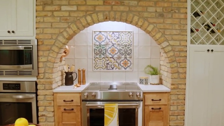 A stone oven range with Spanish tile designed by Erin Napier