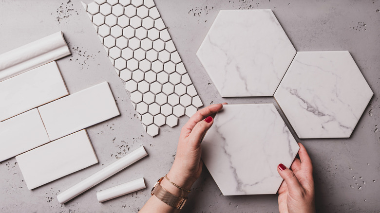 Person laying out tiles