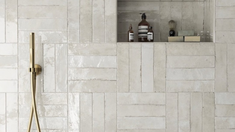 White subway tiles are in a creative layout in a bathroom.