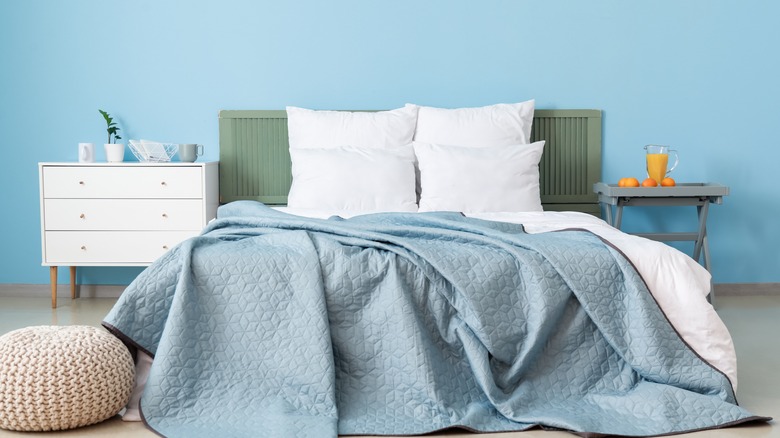 blue bedroom with white sheets