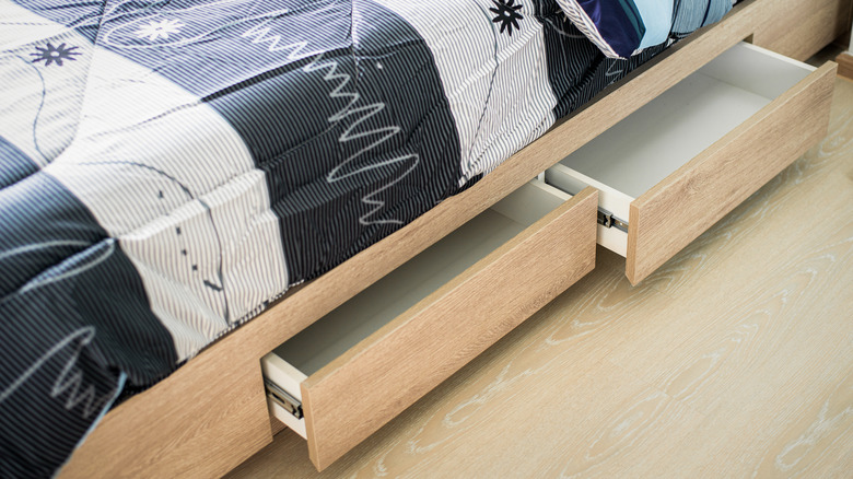 bed with open wood drawers