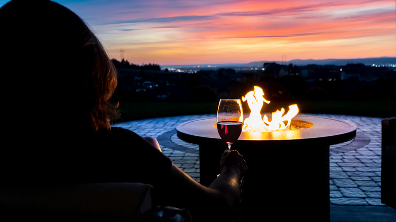 wine glass woman and fire pit