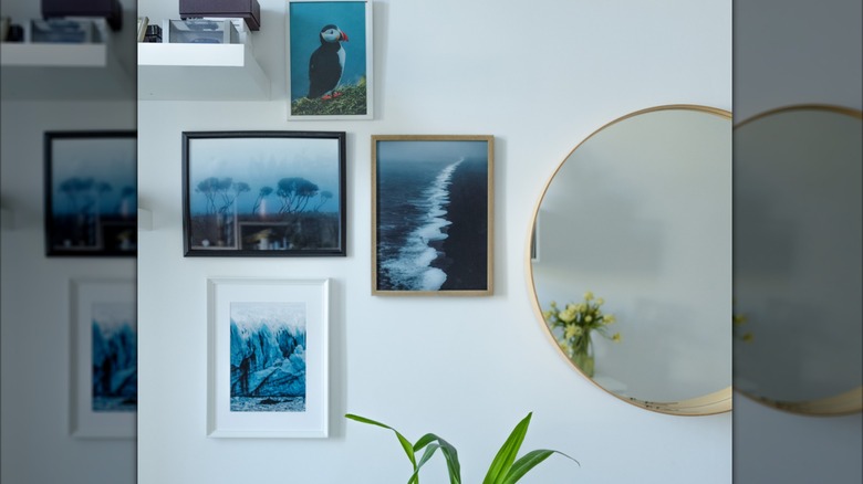 A gallery wall is decorated with a blue color theme