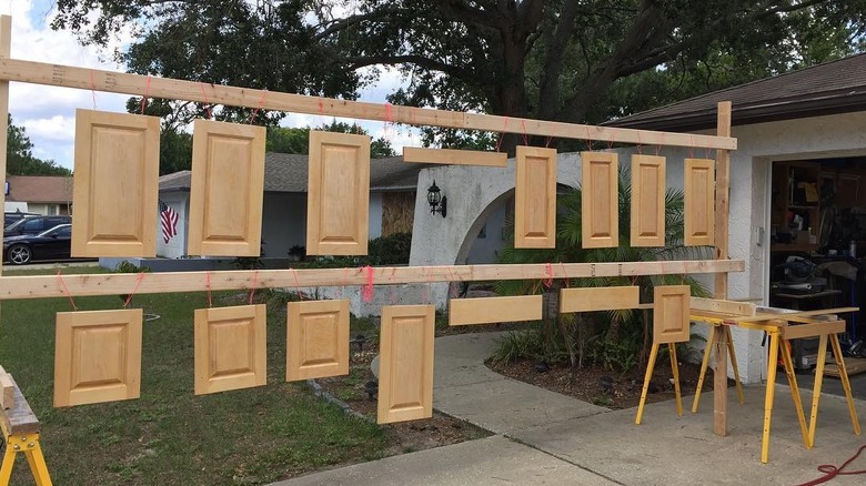 cabinet doors hanging to dry outside house