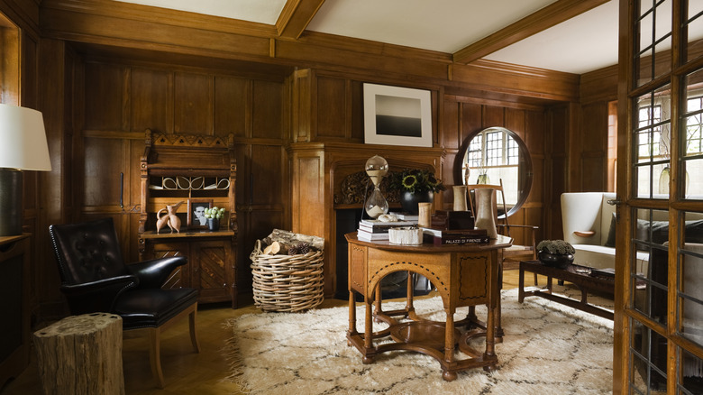 A living room is covered in wood paneling