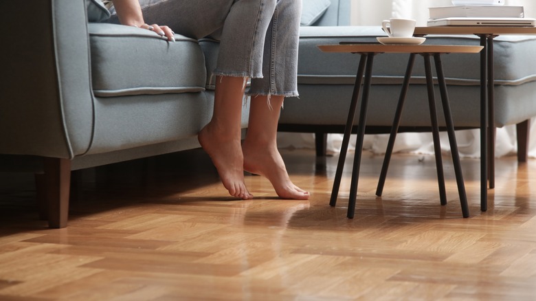 Barefoot person on hardwood floors