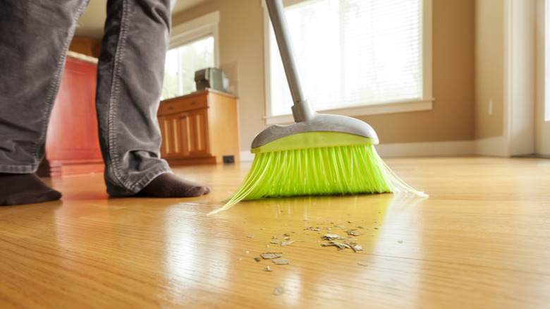 Person sweeping hardwood floors