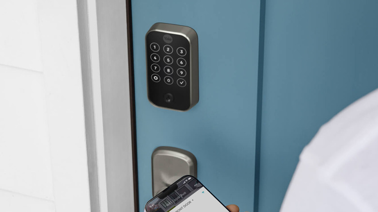 Yale Assure Lock 2 on a blue door with someone's phone app open