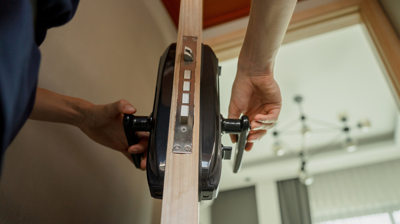 Technician installing a smart lock in a door