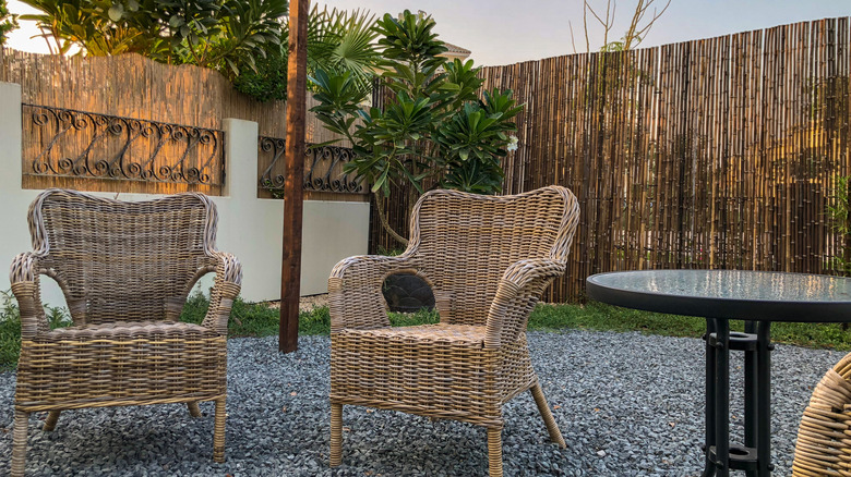 outdoor seating area with bamboo privacy fence