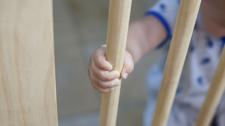 Baby holding bar on baby gate