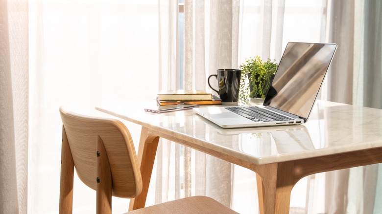 Small desk with laptop computer