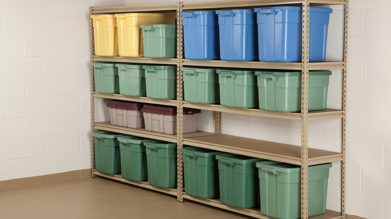 Shelves in a garage with colorful bins