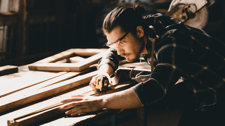 carpenter taking measurements