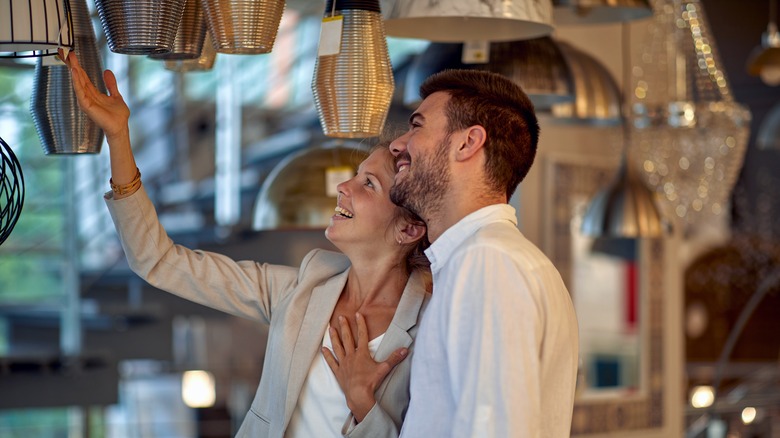 Couple selecting light fixture