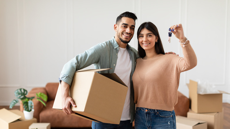 couple holding box and keys