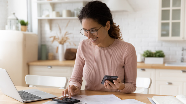 Woman with calculator and papers