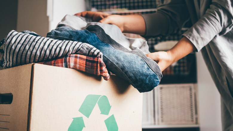 Person storing clothes in box