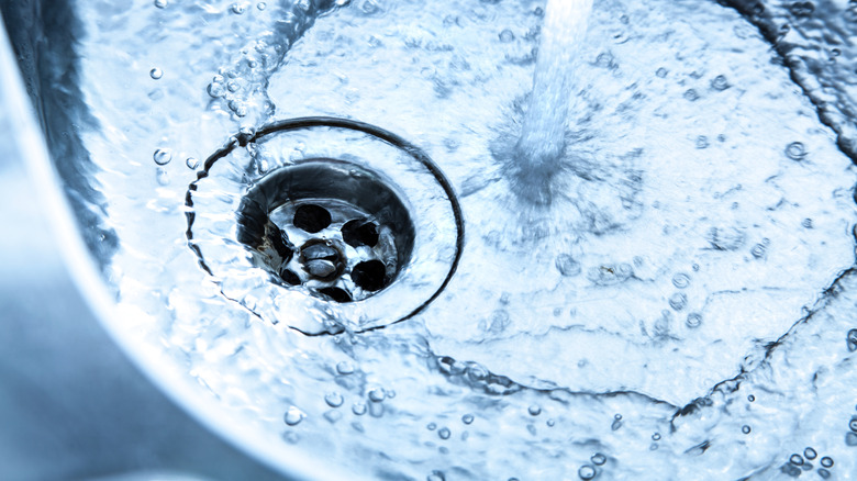 Water flows into a clean stainless steel sink