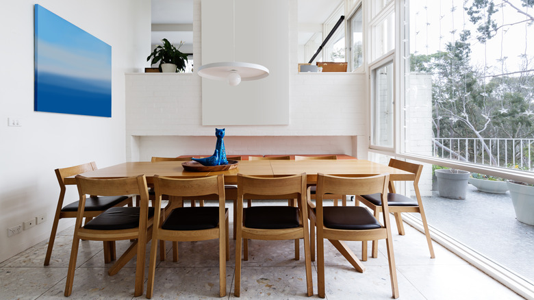 Wooden dining table in airy dining room