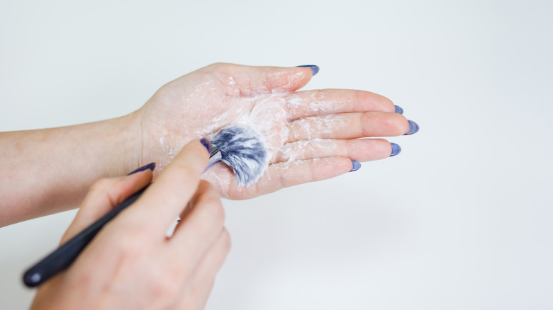 Woman cleaning paint brush