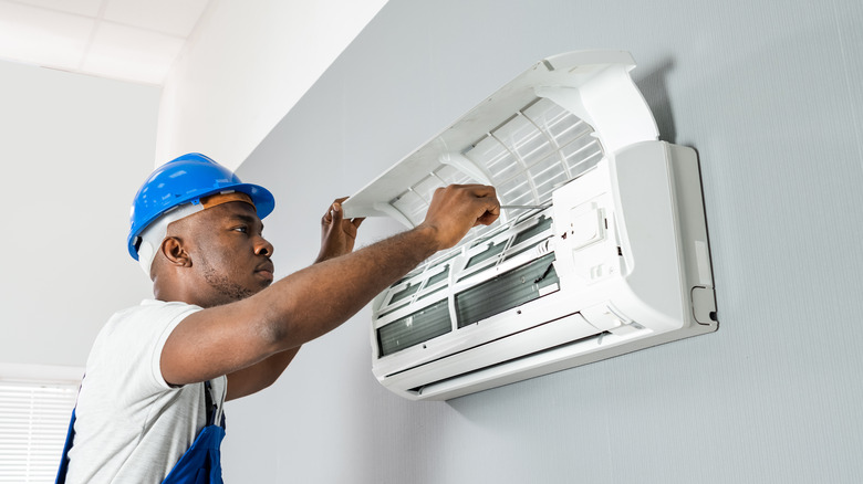 Man repairing air conditioner 