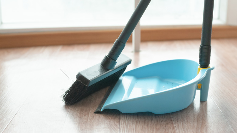 close-up of broom and dustpan