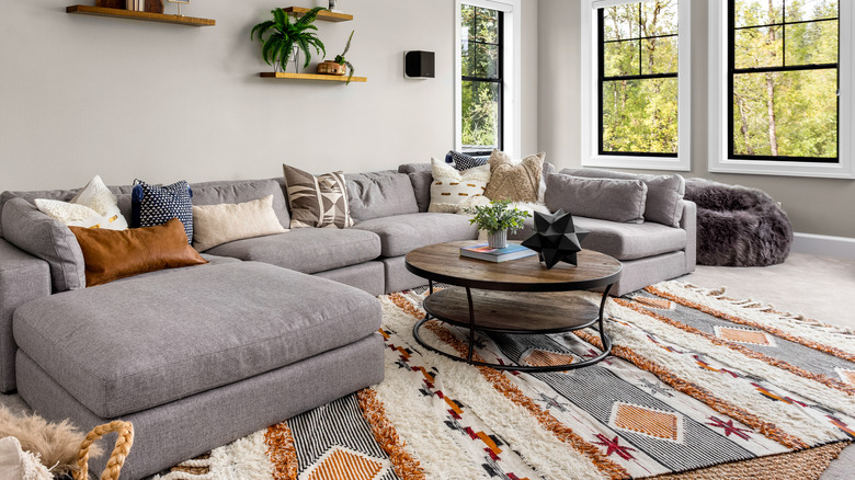 A living room with a multicolored area rug